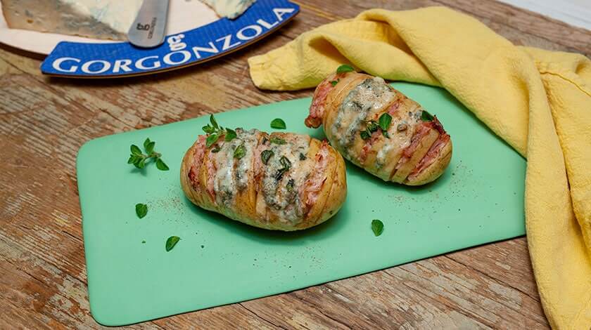 Hasselback potatoes with cooked ham, fresh oregano and spicy Gorgonzola PDO - Gorgonzola DOP